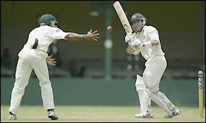Damien Martyn just evades a Pakistani fielder's attempt to catch him