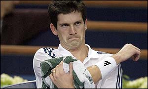 Britain's Tim Henman grimaces as he loses control of the match