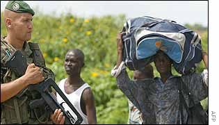French soldier watching fleeing civilians 