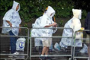Tennis fans queue in the rain on Monday morning