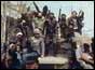 Civilians brandishing guns on armoured car
