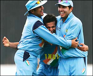 Irfan Pathan is mobbed after taking his third wicket