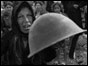 Refugee holds up helmet