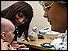 GP giving child vaccination