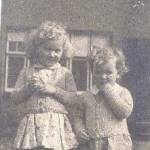 Joan and her sister Gillian outside their house in Shooters Hill, London. Note the blast damaged windows. The house was later made uninhabitable by bombing.
