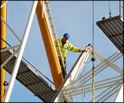 Workman puts the sections of the Big Wheel together