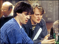 Two men looking at their beers