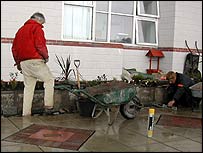 Mike working on the wall in the rain