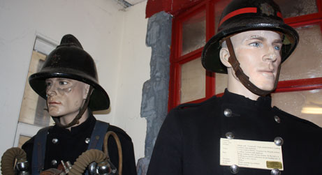 Photograph of mannequins dressed as firemen