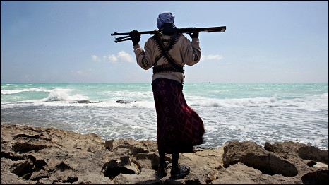 A Somalian pirate looks out to sea
