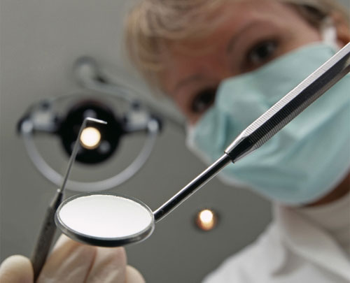 Dentist with implements