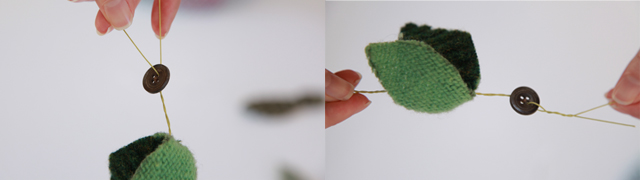 Hands holding a small button and leaf shapes made from fabric and thread