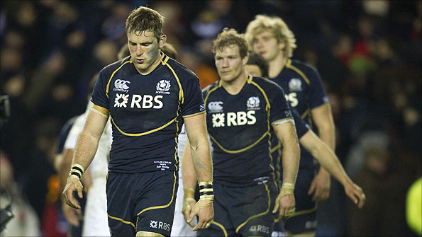 Scotland players look dejected after losing against England.