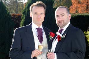 Characters in the BBC radio soap opera The Archers, Adam Macy and as his partner Ian Craig, at their Civil Partnership ceremony.