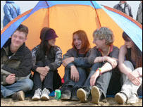 Festival goers sheltering from rain