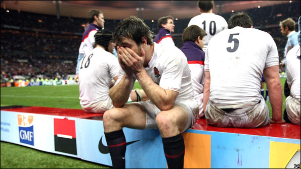 Full-back Ben Foden holds his head in his hands at the end of England's defeat by France.jpg