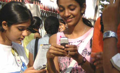 Girls in India using mobile phones