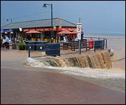Flood water pours over Filey sea wall
