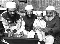 Salim Kholwadia (second left) uses his computer skills to help his family and the wider community. (Picture: Alexander Caminada)