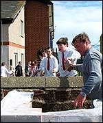 John Murphy passes bricks over the wall