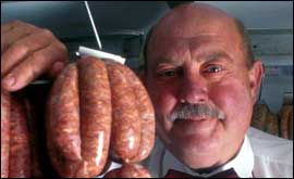 Butcher holding sausages