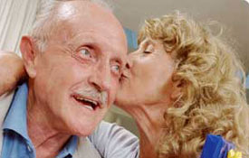 Elderly couple kissing