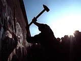 NOVEMBER 12TH 1989: a man hammering at the Berlin Wall, as the border barrier between East and West Germany was torn down after 28 years.