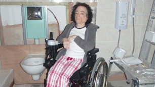 Liz Carr looking impatient in her bathroom