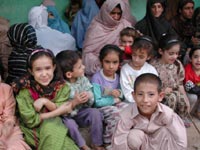 Pakistani women in Islamic dress with their children
