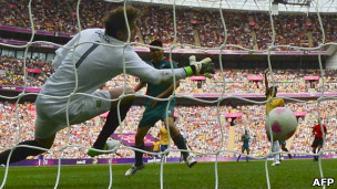 Brazil's goalkeeper Gabriel fails to catch a shot by Mexico's forward Oribe Peralta at Wembley stadium