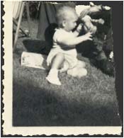 Robert Butler as a baby. His father's image has been torn from the picture