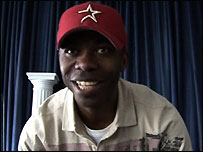Smiling black man wearing red baseball cap