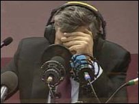 Gordon Brown in a radio studio listening back to his own comment