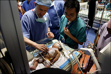 Surgeon David Barron checks on a patient post-op