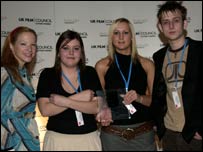 The producers receive the award from Natalie Press