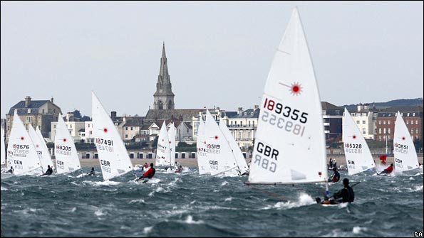 The men's Laser fleet head down wind towards Weymouth during the Skandia Sail for Gold Regatta 