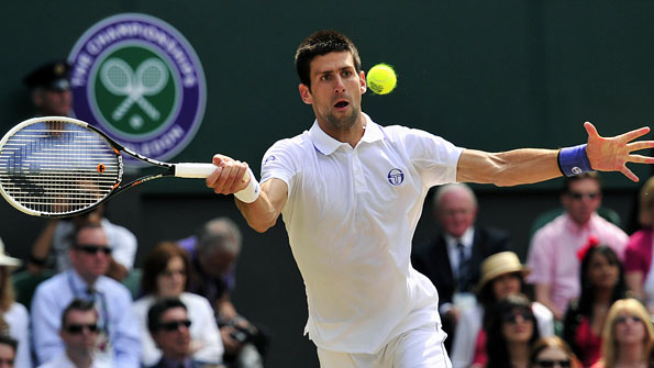Novak Djokovic returns a shot in his men's final with Rafael Nadal at Wimbledon 2011
