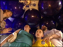 Murray family surrounded by balloons