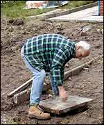 Helper moves a paving slab