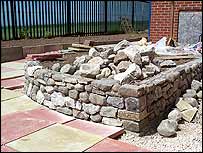 Raised bed surrounded by coloured slabs