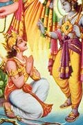 Arjuna, quiver of arrows on his back and a bow by his feet, kneels before Krishna who is making a sign of blessing