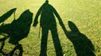 Shadows on the grass of a family