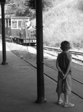 Young boy waits for his train