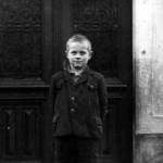 Herbert, aged 9, in front of his primary school