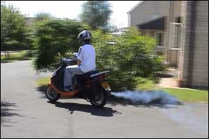 Richard Loftus on his moped