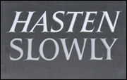 Hasten Slowly sign