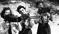 Members of the WAAF test aerial guns after repair work