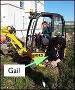 Paul using the digger with Gail in the foreground