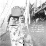 Charles Hladky (standing) with buddy holding Japanese banner. Okinawa, Japan at end of war.