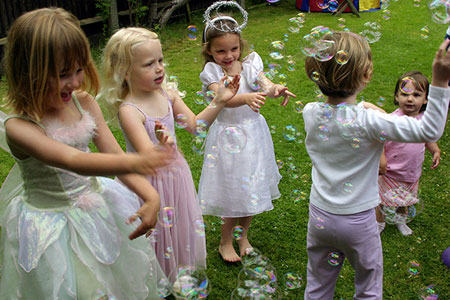 Children blowing bubbles, photo by Tom Ang